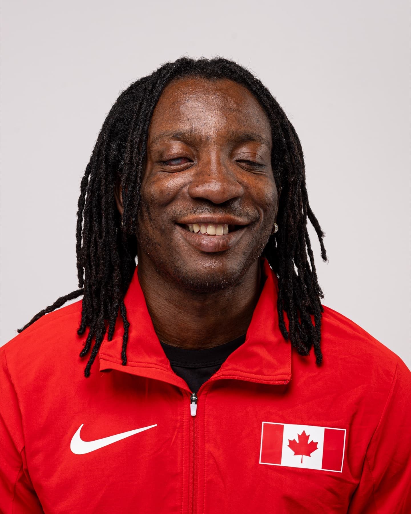 George Quarcoo smiling in a red Team Canada jacket
